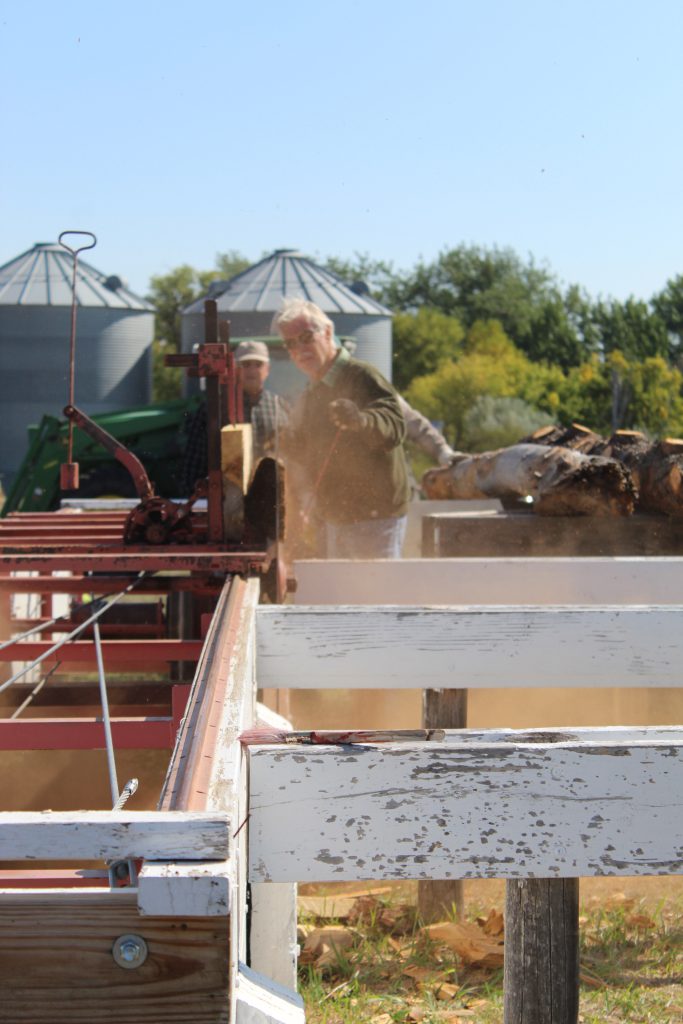 Dennis Sievers running the sawmill on Heritage Hill